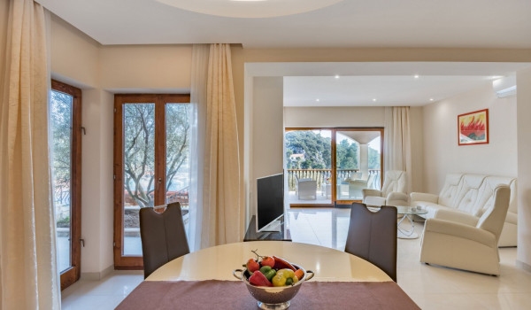 Dining table and comfortable sofas on the first floor of the luxury holiday villa with private pool and sauna