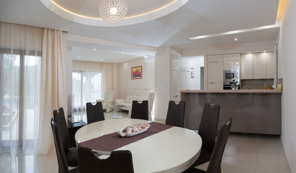 Dining table and kitchen of the luxury beachfront villa for family vacation on Korcula island