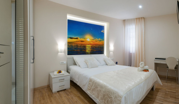 Double bed in a bedroom of a luxury Korcula villa with concierge service and sea view