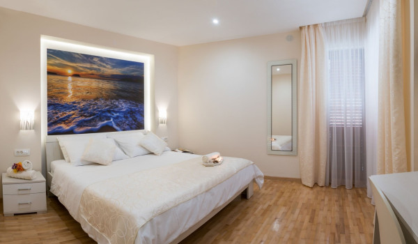Double bed in a bedroom of a luxury Korcula villa with concierge service and sea view