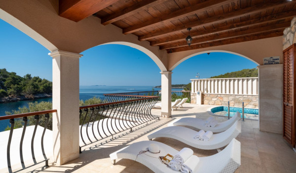 Deck chairs by the pool on the terrace of the luxury vacation villa with concierge service and private parking