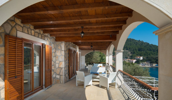 Seating area on a balcony of a luxury Korcula villa for family vacation by the sea