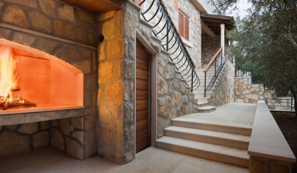 Staircase from the terrace to the grill area of the luxury holiday villa with concierge service and heated pool