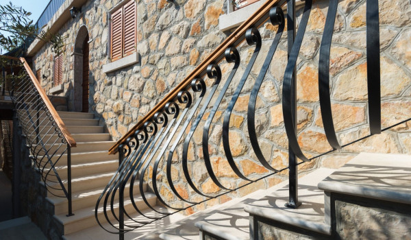 Staircase from the terrace to the grill area of the luxury holiday villa with concierge service and heated pool