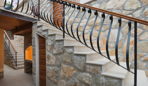 Staircase from the terrace to the grill area of the luxury holiday villa with concierge service and heated pool