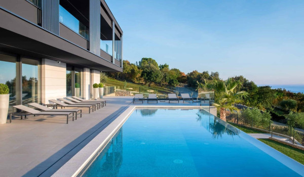Deck chairs by the heated pool in istrian luxury family villa for rent with sea view