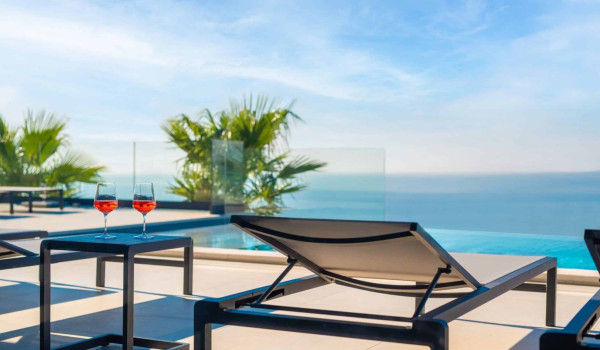 Deck chairs by the heated pool in istrian luxury family villa for rent with sea view