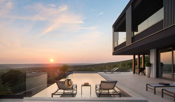 Deck chairs by the heated pool in istrian luxury family villa for rent with sea view