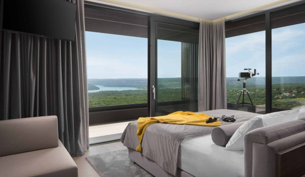 Bedroom with king size bed and en suite bathroom with shower in istrian luxury family villa