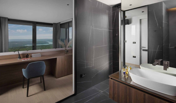 Bedroom with king size bed and en suite bathroom with shower in istrian luxury family villa