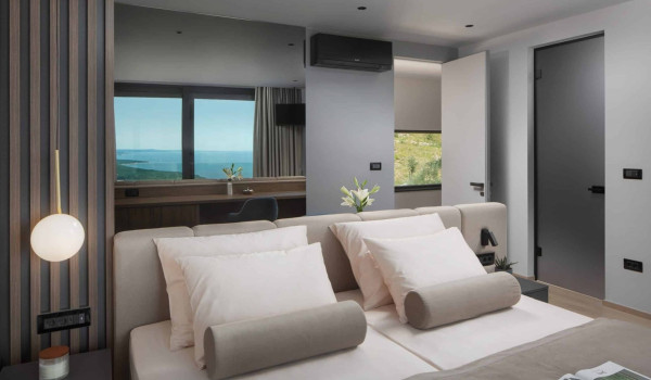 Bedroom with king size bed and en suite bathroom with shower in istrian luxury family villa