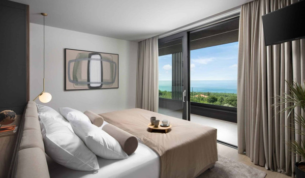 Bedroom with king size bed and en suite bathroom with shower in istrian luxury family villa