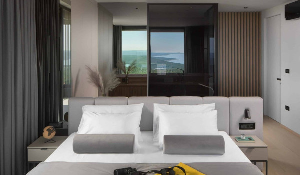 Bedroom with king size bed and en suite bathroom with shower in istrian luxury family villa