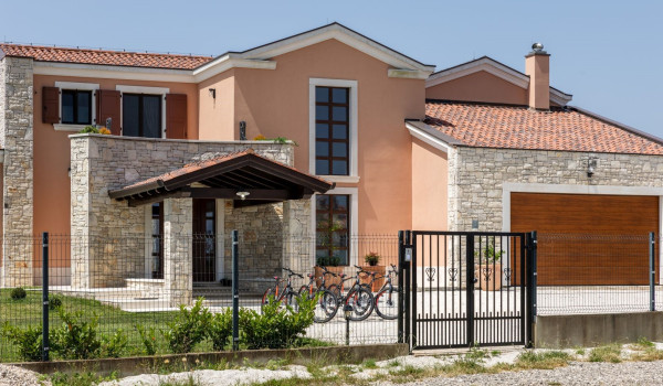 View of the exterior of a luxury Croatian villa for vacation and rental with a heated outdoor pool in Istria