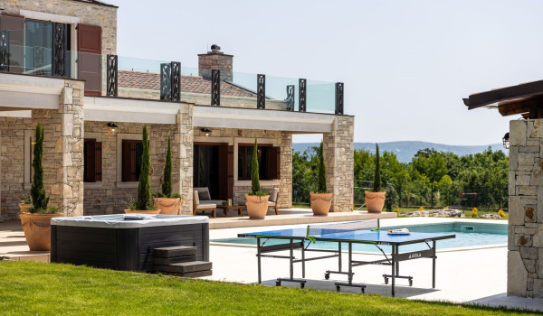 View of the exterior of a luxury Croatian villa for vacation and rental with a heated outdoor pool in Istria