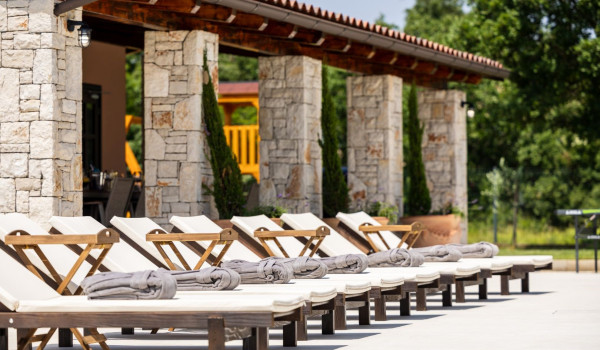 Comfortable sunbeds located next to the private heated pool on the property of the luxury villa Bella Casa
