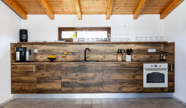 A view of the outdoor kitchen located opposite the residential part of the luxury villa for rent and vacation