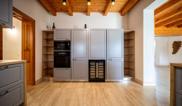 Fully equipped kitchen with a bar and two bar stools inside the ground floor of the Croatian luxury villa for vacation and rent