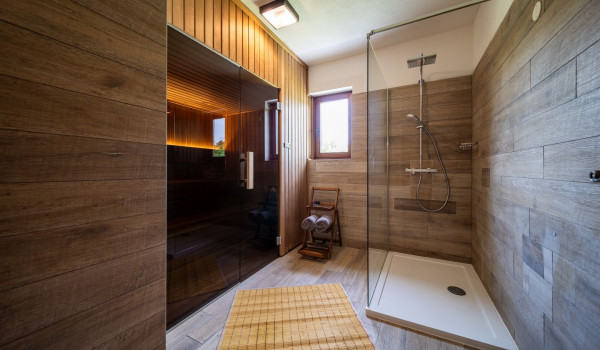 Finnish sauna with toilet and walk-in shower inside a luxury Croatian villa for rent and vacation