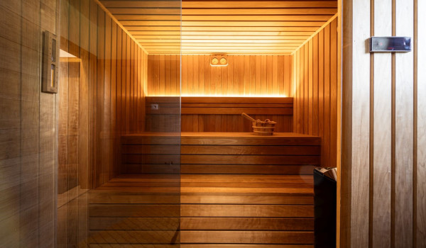 Finnish sauna with toilet and walk-in shower inside a luxury Croatian villa for rent and vacation
