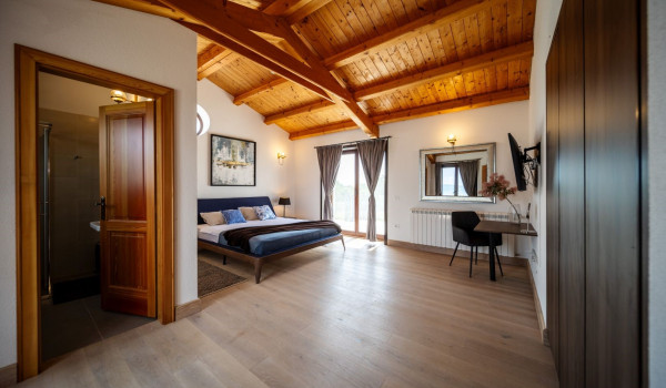 Luxurious, spacious bedroom with king-size bed and en-suite bathroom with walk-in shower