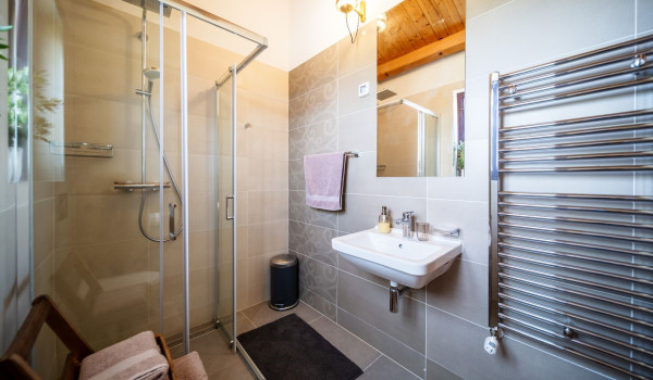 Luxurious, spacious bedroom with king-size bed and en-suite bathroom with walk-in shower