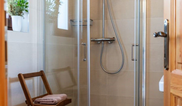 Luxurious, spacious bedroom with king-size bed and en-suite bathroom with walk-in shower