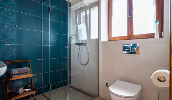 Luxurious, spacious bedroom with king-size bed and en-suite bathroom with walk-in shower