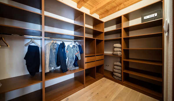 A wardrobe inside a naturally lit, modern room for vacationing with friends or family in Istria