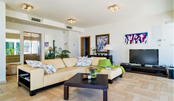 Living room with large comfortable sofa and TV in a Dubrovnik luxury villa for family vacation