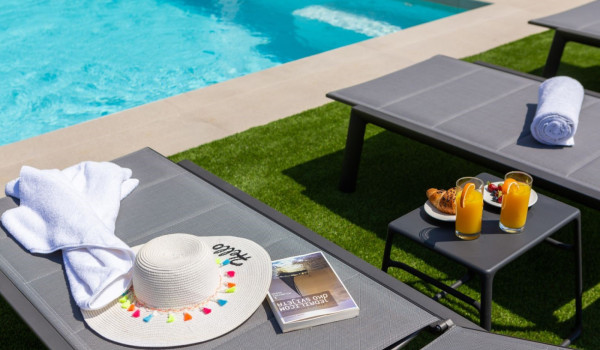 Comfortable deckchairs by the private pool on the property of a Croatian luxury villa for rent and vacation