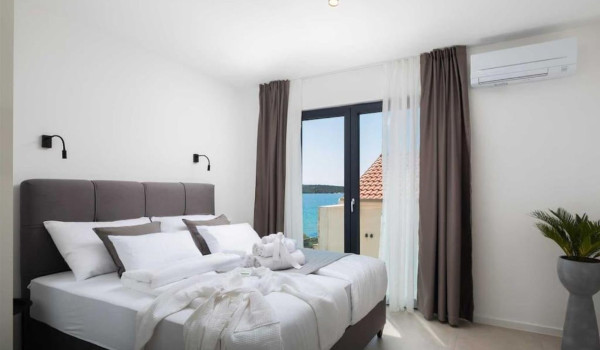 Modern double bedroom with sea view and en-suite bathroom