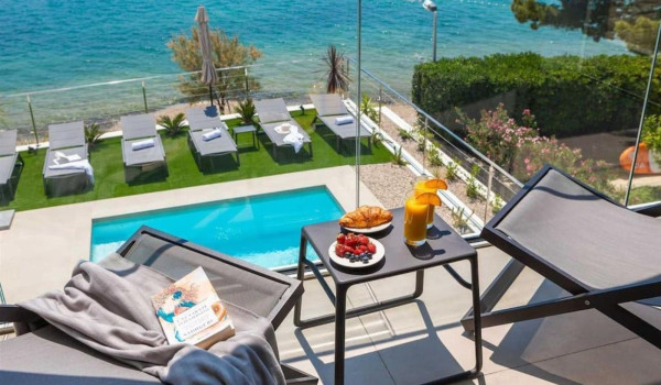 Sitting area on the property of a Croatian luxury villa for rent and holiday with a view of the sea