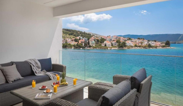 Garden furniture on the property of a luxury Croatian villa for rent and vacation with a view of the sea