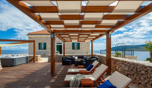 Terrace with jacuzzi and outdoor furniture in luxury seafront villa on Vis for vacation and rent.