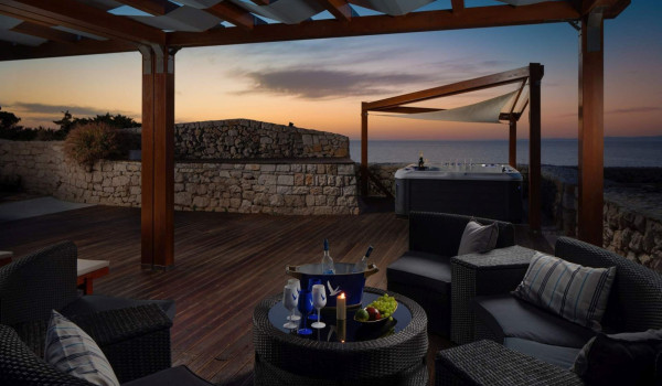 Outdoor furniture with served drinks in luxury private villa Lighthouse Ligero on Vis with jacuzzi by the sea.