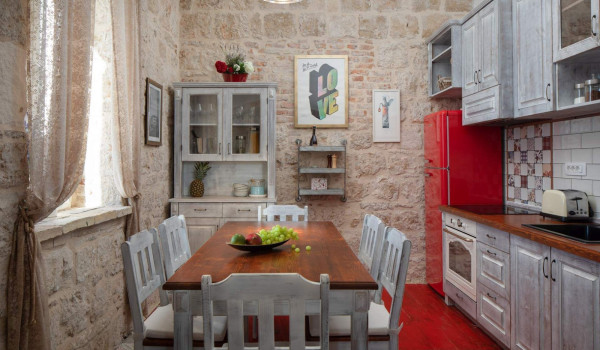 Equipped kitchen and rustic dining room in Vis luxury private villa for vacation and rent.