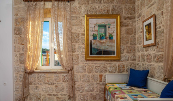 Living room with colorful sofa in Croatian luxury seafront villa on Vis by the sea for total privacy