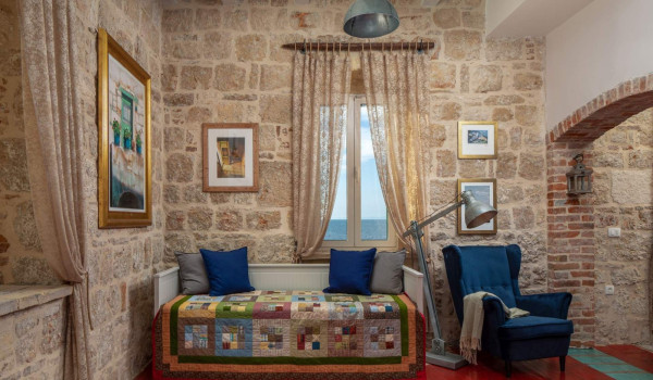 Living room with colorful sofa and armchair in luxury seafront villa on Vis by the sea for total privacy