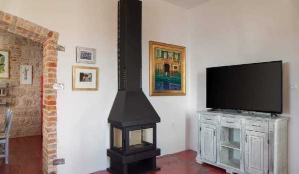 Indoor fireplace in living room of Croatian luxury holiday villa Lighthouse Ligero on Vis by the sea for vacation and rent.