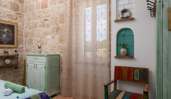 Playfuly decorated bedroom in seafront luxury villa on Vis with jacuzzi.
