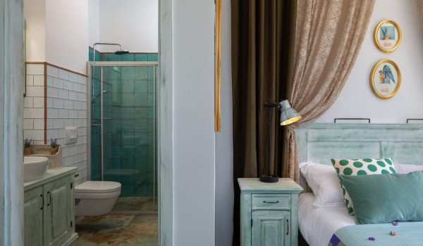 Spacious bedroom with King-size bed and en suite bathroom in luxury villa on Vis for vacation and rent.