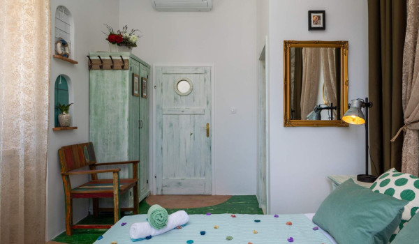 Spacious bedroom with King-size bed and en suite bathroom in luxury villa on Vis for vacation and rent.