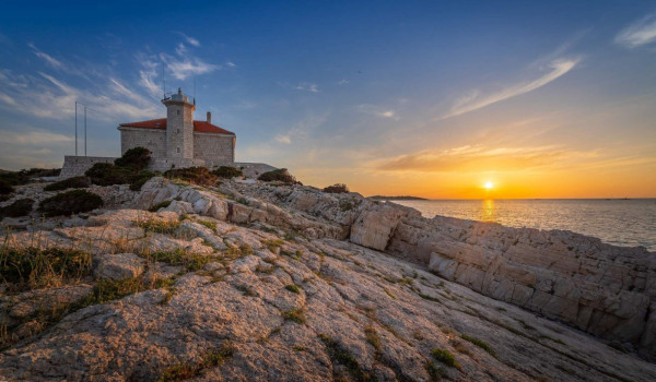 Beautiful sunset near luxury seafront villa Lighthouse Ligero on Vis for vacation and rent.