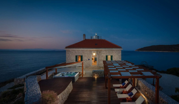 Terrace with jacuzzi and outdoor furniture in luxury seafront villa on Vis for vacation and rent.