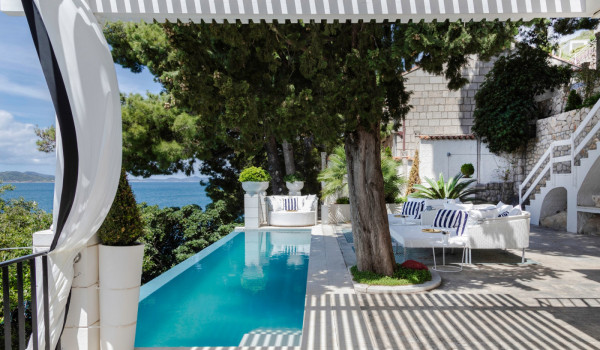 Lounge chairs by the infinity pool on the terrace of the Croatia beachfront villa Sea Diamant