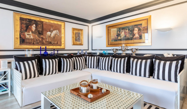Big comfortable sofa and table in the living room of the vacation villa by the sea with private beach