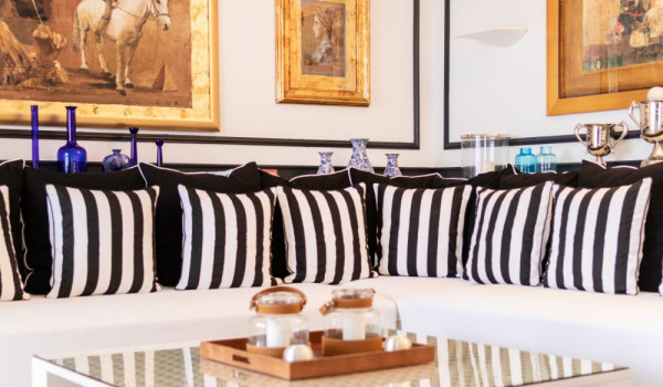 Big comfortable sofa and table in the living room of the vacation villa by the sea with private beach