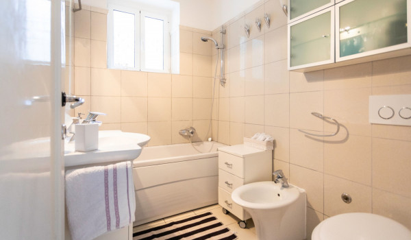 Bathroom with sink, toilet and tub of the modern vacation villa in Dubrovnik with private beach