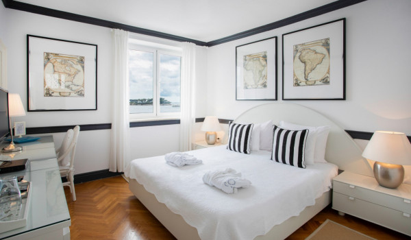 Bedroom with king size bed and working station in the luxury beachfront villa with parking and wifi